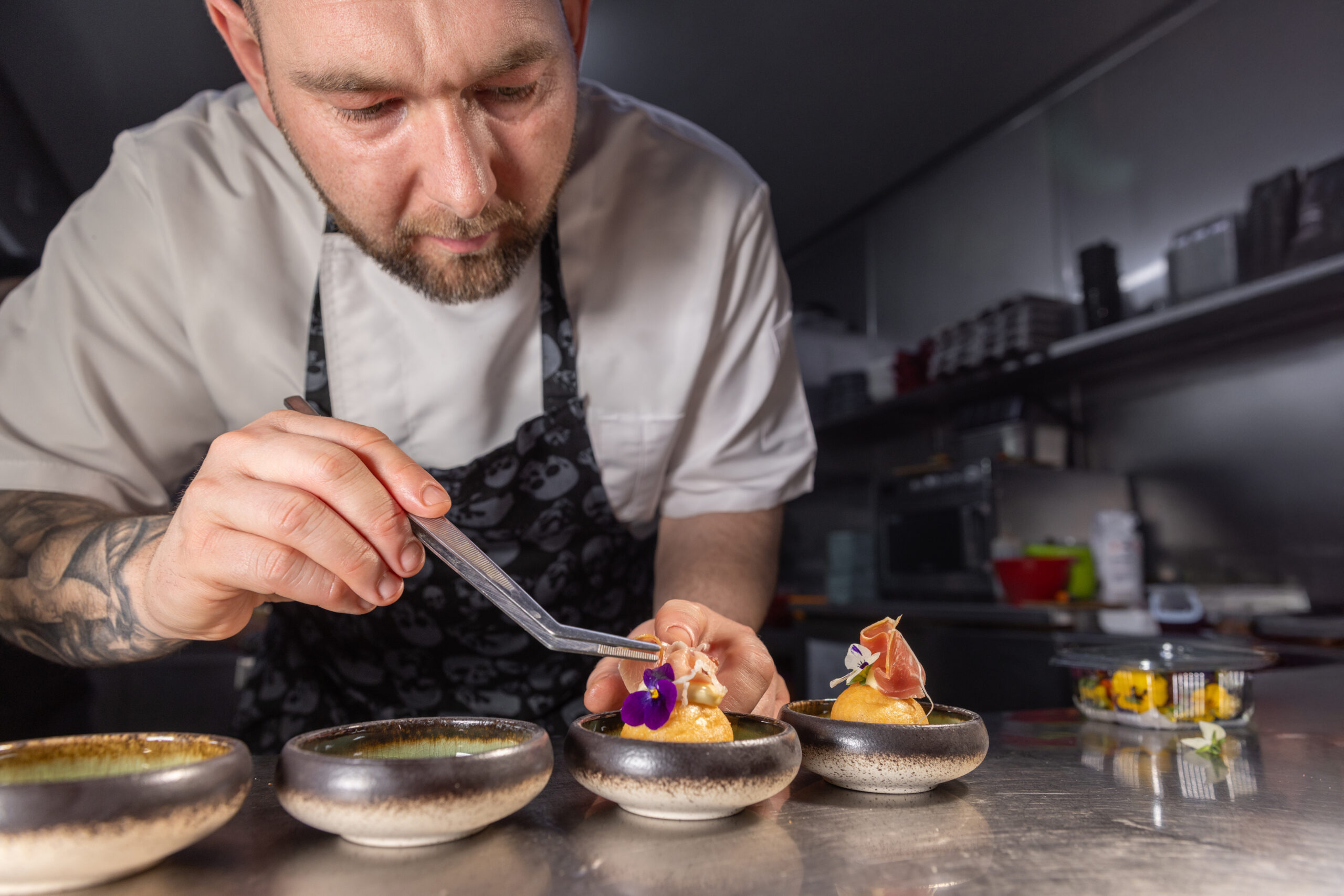 Professional chef garnishing small appetizers