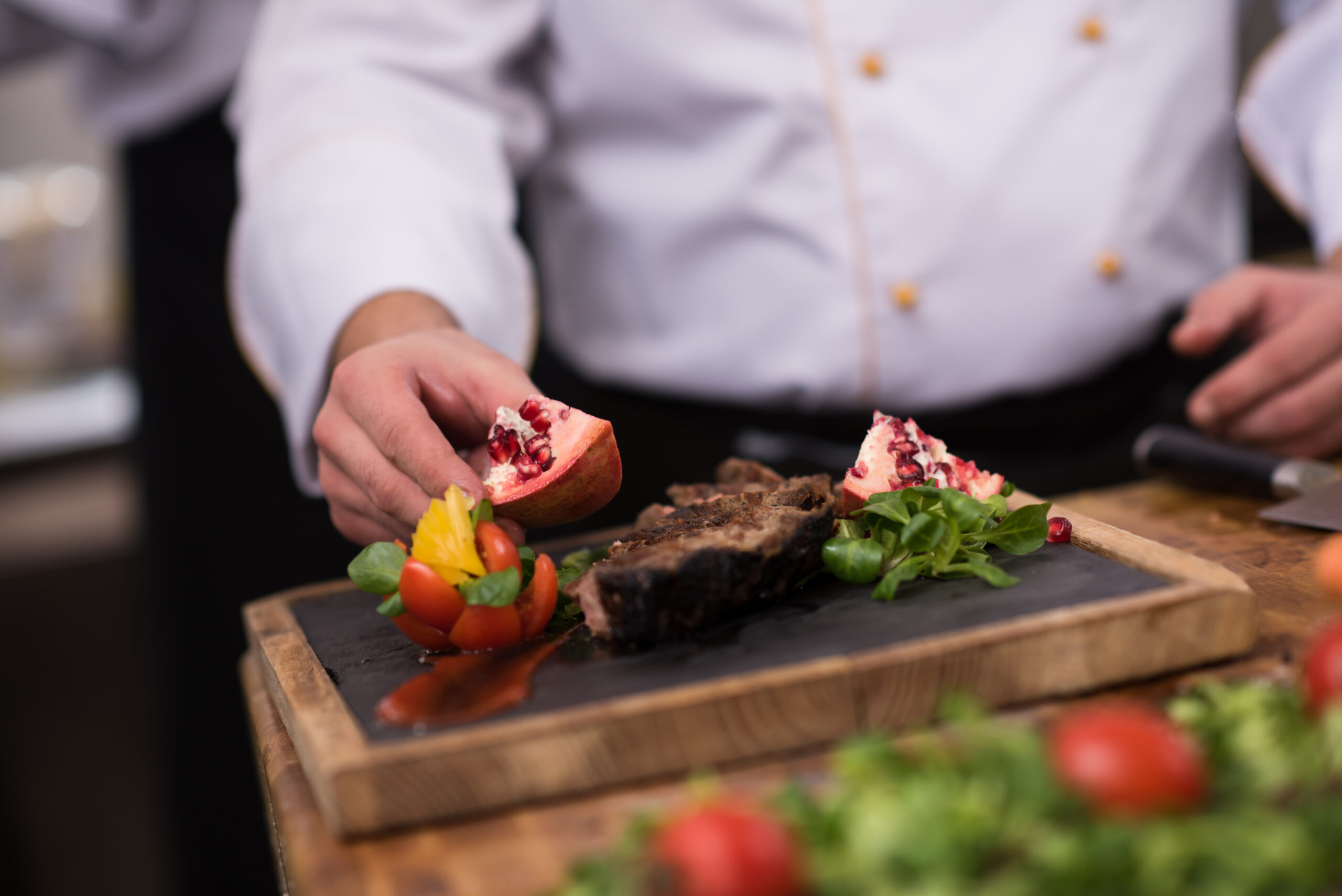 closeup of Chef hands serving beef steak